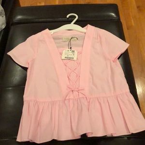 Girl’s Zara soft pink top.